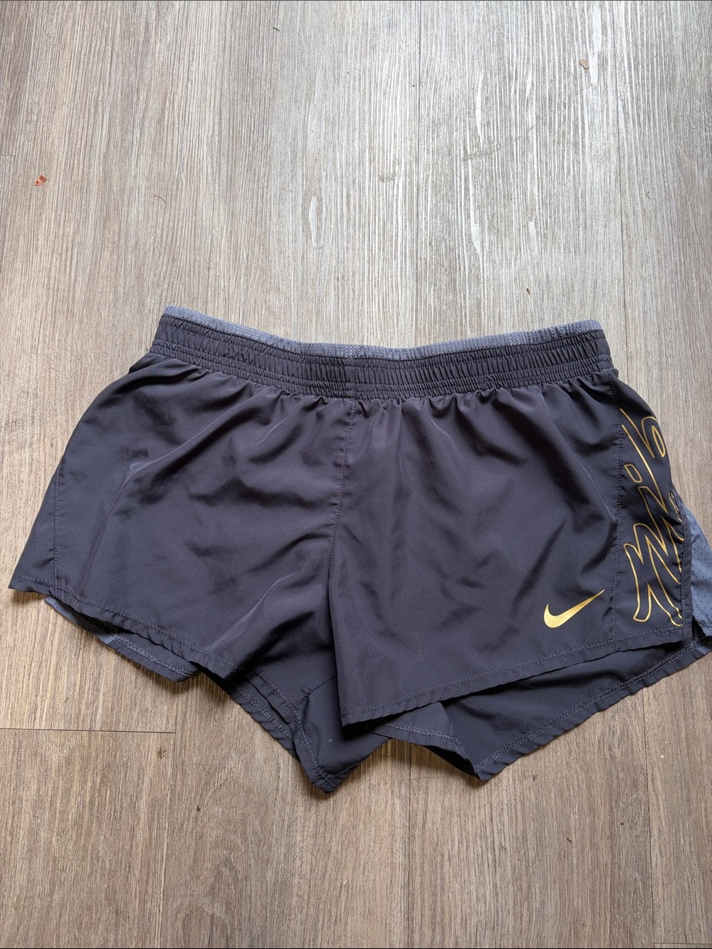 Nike Women's Black Athletic Shorts with Gold Logo Accent